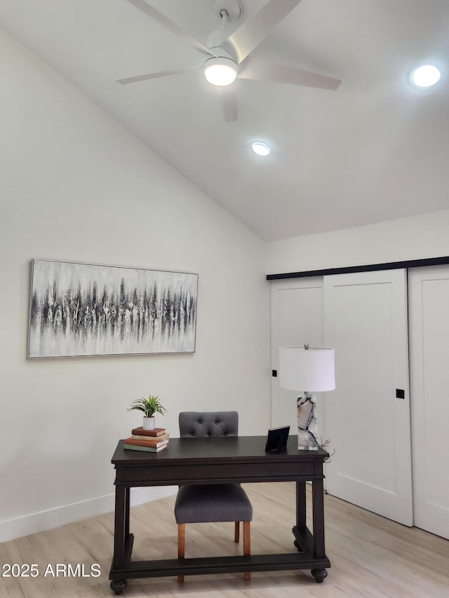 office area featuring light wood-type flooring, ceiling fan, and lofted ceiling