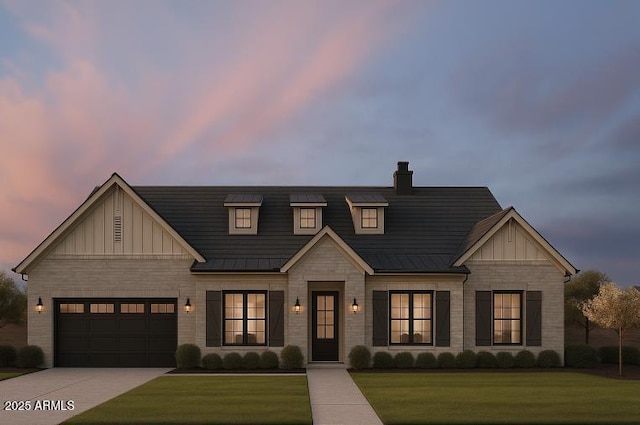 modern farmhouse style home featuring board and batten siding, driveway, and a front yard