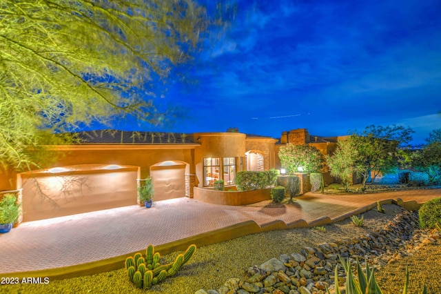 pueblo-style house with a garage
