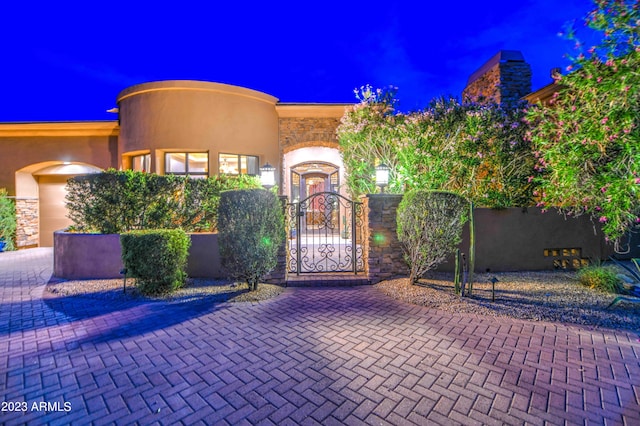 view of gate at twilight