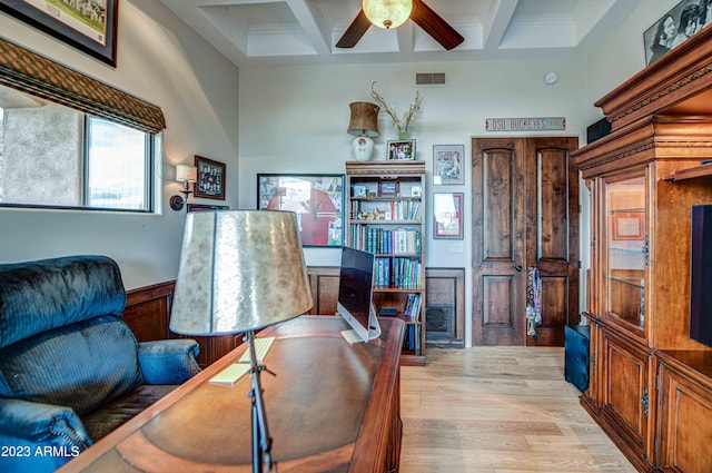 office space with coffered ceiling, light hardwood / wood-style floors, ceiling fan, and beam ceiling