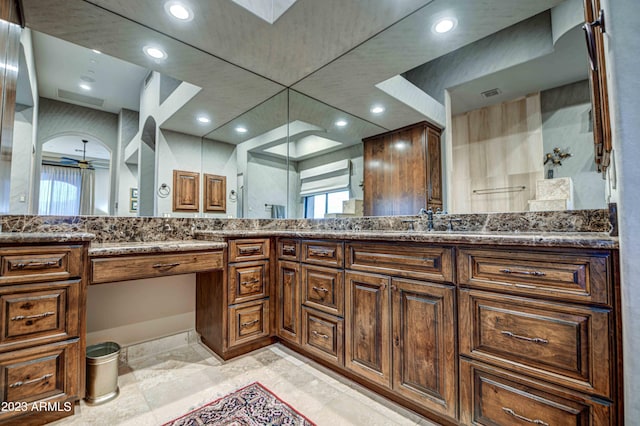 bathroom with dual sinks, vanity with extensive cabinet space, and tile flooring