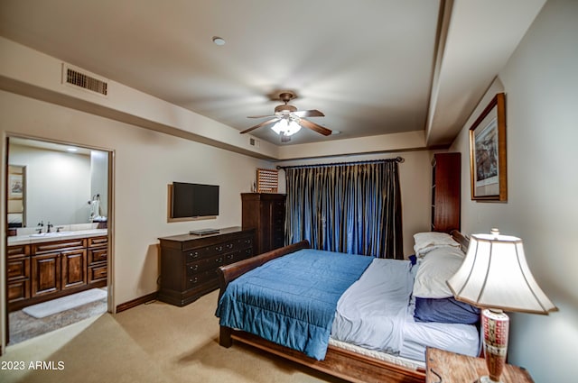 carpeted bedroom with ceiling fan, sink, and ensuite bathroom