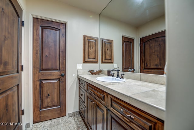bathroom with tile floors and vanity