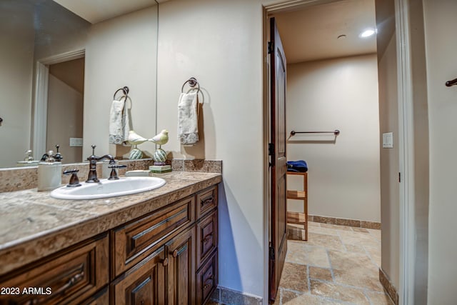 bathroom with tile floors and vanity
