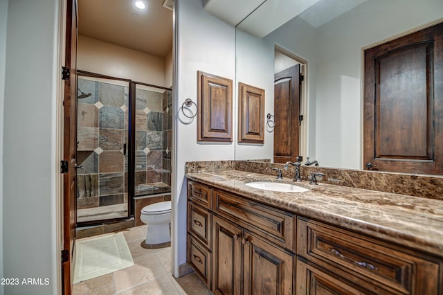 bathroom with walk in shower, toilet, tile floors, and large vanity
