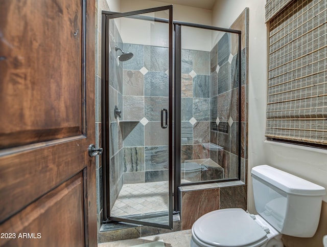 bathroom featuring toilet and walk in shower