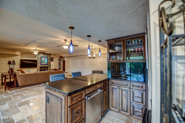kitchen with ceiling fan, light tile floors, sink, decorative light fixtures, and dark brown cabinetry