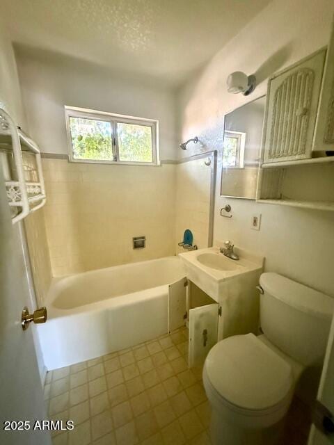735 E Desert Ave, Apache Junction, AZ 85119 - bathroom with toilet, tile patterned flooring, and tub / shower combination