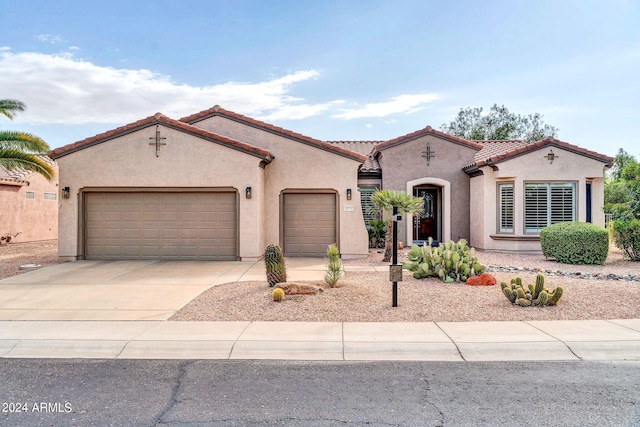 mediterranean / spanish house featuring a garage