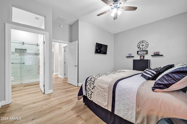 bedroom featuring ceiling fan, ensuite bath, and light hardwood / wood-style floors