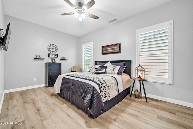 bedroom with light hardwood / wood-style floors and ceiling fan