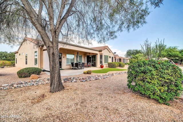 back of house with a patio area