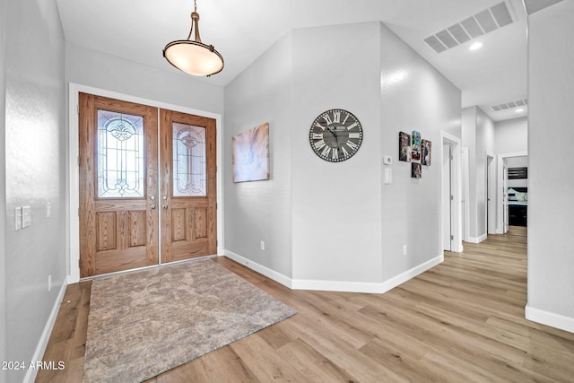 entrance foyer featuring light hardwood / wood-style floors and french doors