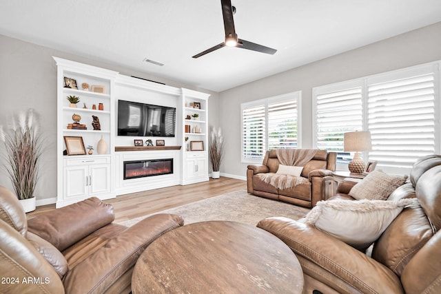 living room featuring light hardwood / wood-style floors and ceiling fan