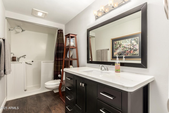 bathroom with toilet, a shower with shower curtain, vanity, and hardwood / wood-style floors