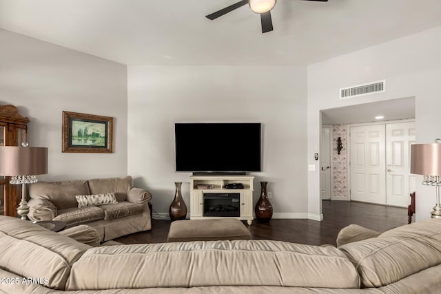 living room with ceiling fan and dark hardwood / wood-style floors