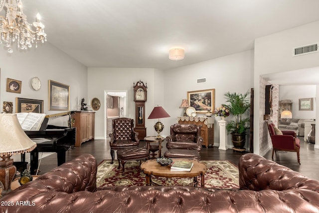 living room with an inviting chandelier and dark hardwood / wood-style flooring