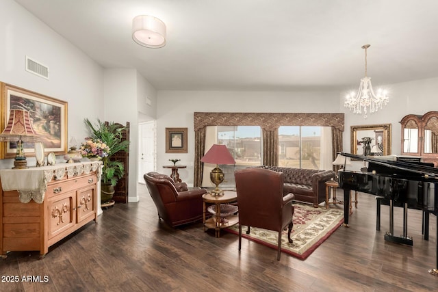 living room featuring a chandelier and dark wood-type flooring