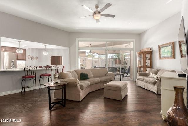 living room with ceiling fan and dark hardwood / wood-style flooring