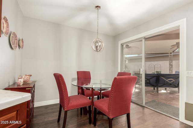 dining room with a notable chandelier and dark hardwood / wood-style floors