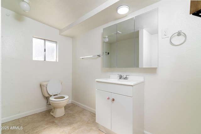 bathroom with vanity, toilet, and tile patterned flooring