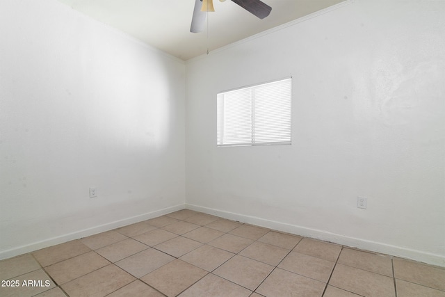 tiled spare room featuring crown molding and ceiling fan