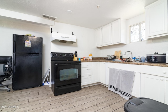 kitchen featuring white cabinetry, sink, and black appliances