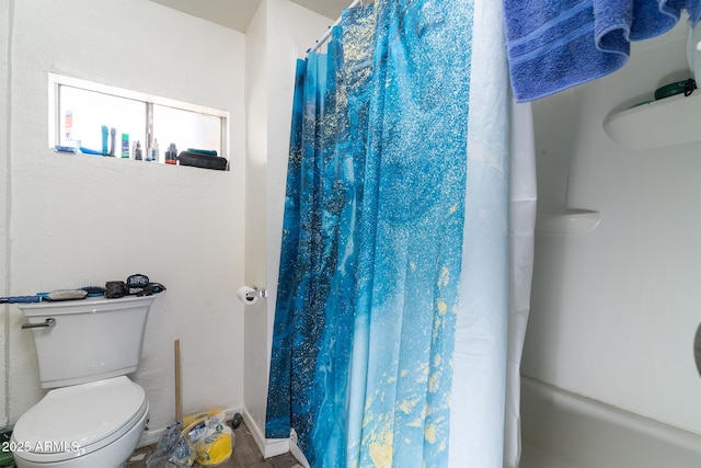 bathroom featuring walk in shower and toilet