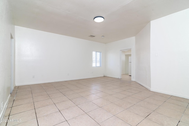 empty room with light tile patterned flooring