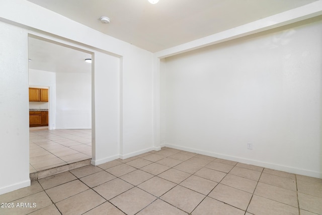 empty room with light tile patterned flooring