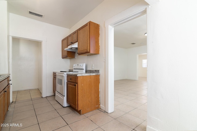 kitchen with light tile patterned floors and electric stove