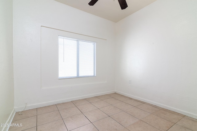 spare room featuring ceiling fan and light tile patterned floors