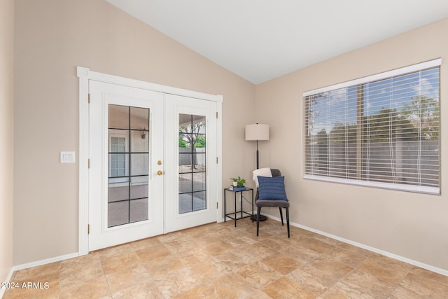 doorway to outside with light tile patterned flooring, french doors, and lofted ceiling