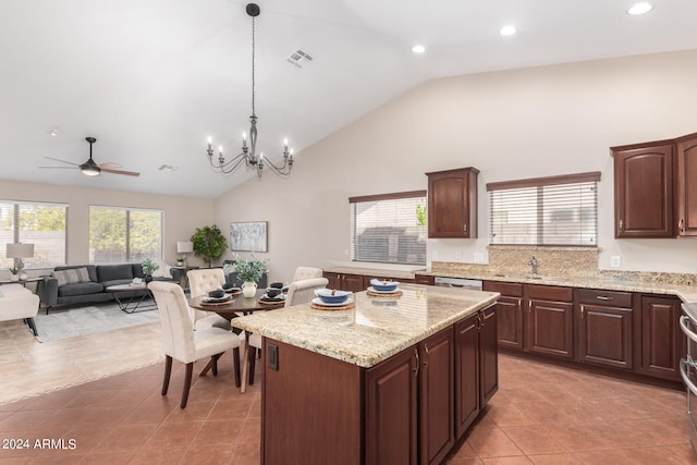 kitchen featuring light stone countertops, light tile patterned floors, and a kitchen island