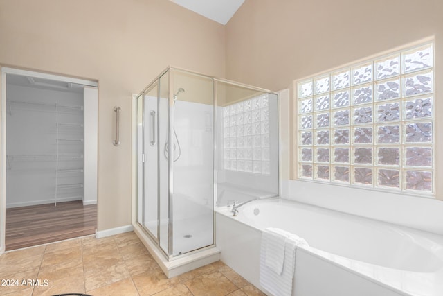 bathroom with wood-type flooring and plus walk in shower