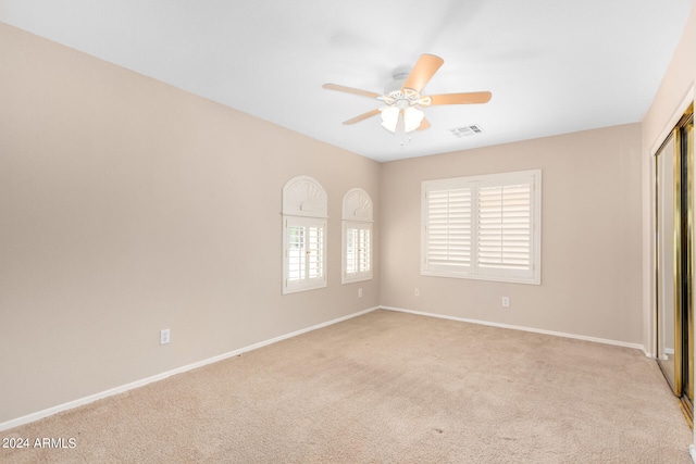 unfurnished bedroom featuring ceiling fan and light colored carpet