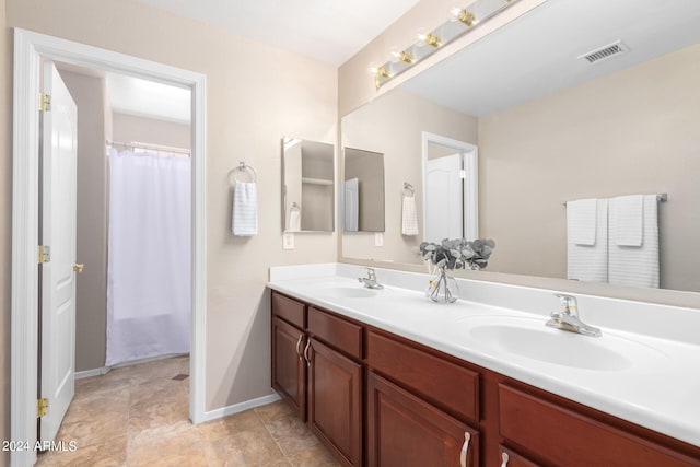 bathroom featuring double vanity and tile patterned flooring