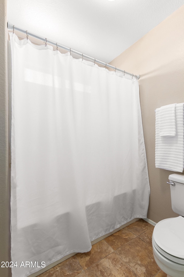 bathroom featuring tile patterned flooring and toilet