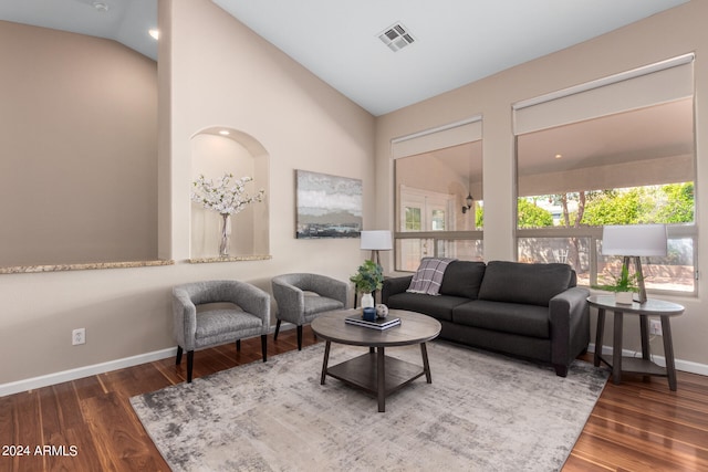 living room featuring high vaulted ceiling and wood-type flooring