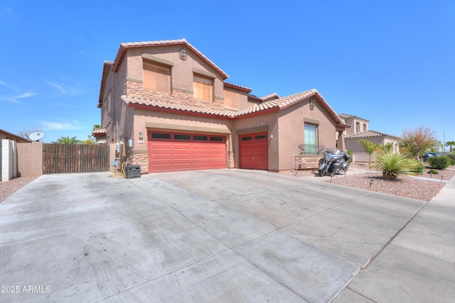 2115 N Cougar Ct, Casa Grande, AZ 85122 - mediterranean / spanish-style home featuring stucco siding, driveway, stone siding, a tile roof, and fence