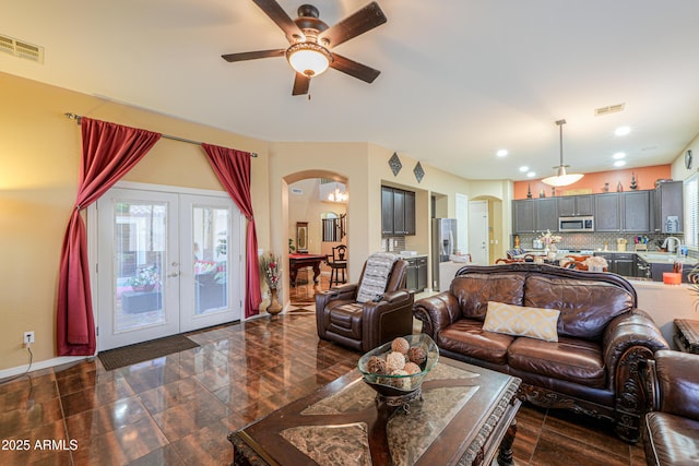 2115 N Cougar Ct, Casa Grande, AZ 85122 - living room featuring french doors, visible vents, a ceiling fan, and arched walkways