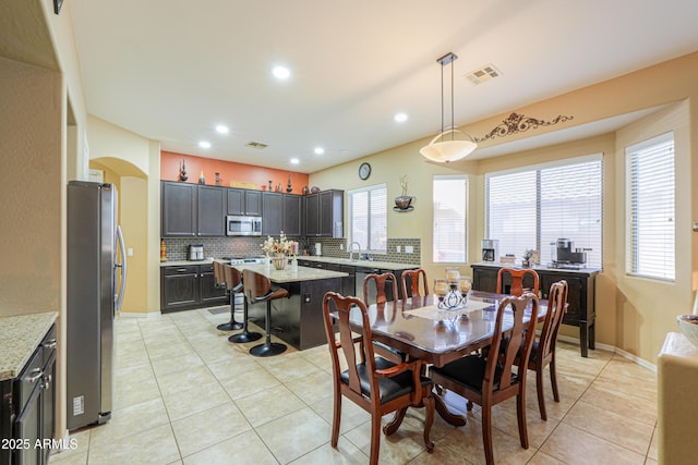 2115 N Cougar Ct, Casa Grande, AZ 85122 - dining area with light tile patterned floors, arched walkways, visible vents, recessed lighting, and baseboards