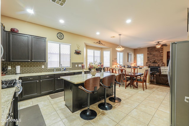 2115 N Cougar Ct, Casa Grande, AZ 85122 - kitchen featuring backsplash, a ceiling fan, visible vents, stainless steel appliances, and a sink