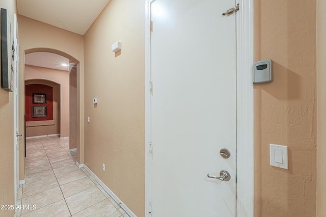 2115 N Cougar Ct, Casa Grande, AZ 85122 - hall with arched walkways, light tile patterned floors, and baseboards