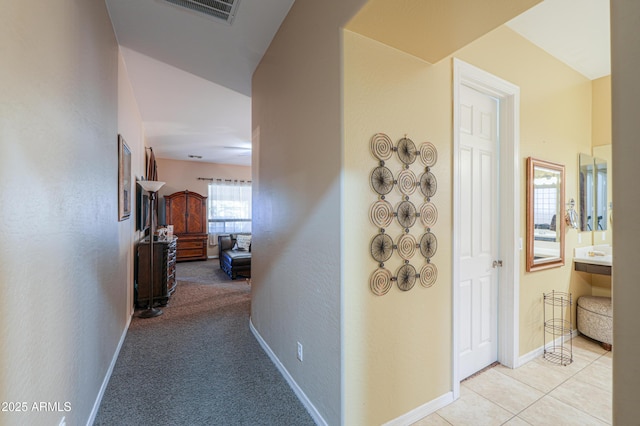 2115 N Cougar Ct, Casa Grande, AZ 85122 - corridor with light colored carpet, light tile patterned floors, baseboards, and visible vents