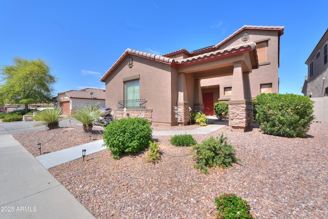 2115 N Cougar Ct, Casa Grande, AZ 85122 - mediterranean / spanish house featuring stucco siding, a tiled roof, and stone siding