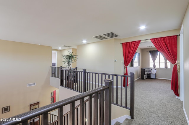 2115 N Cougar Ct, Casa Grande, AZ 85122 - hallway featuring visible vents, baseboards, carpet flooring, and an upstairs landing