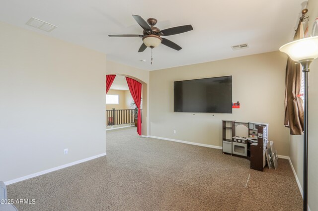 2115 N Cougar Ct, Casa Grande, AZ 85122 - unfurnished living room with arched walkways, ceiling fan, baseboards, and visible vents