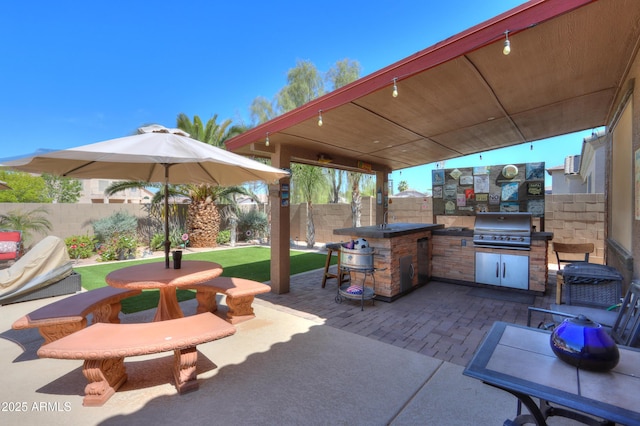 2115 N Cougar Ct, Casa Grande, AZ 85122 - view of patio with a fenced backyard, a sink, an outdoor kitchen, and area for grilling